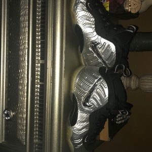 All silver and black Nike Foamposit